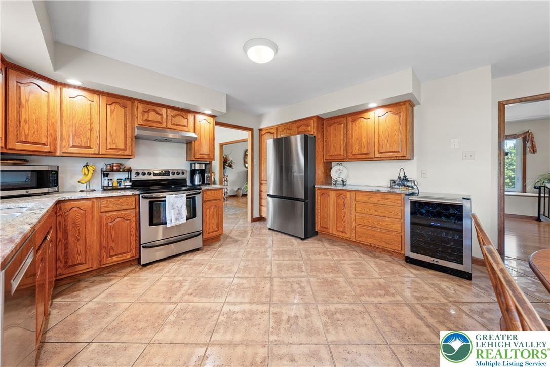 947 Tamenend Road Bath, PA 18014 - Photo 13 of 61 A well-appointed kitchen features ample cabinetry, stone countertops, and modern appliances.