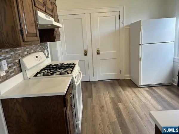 a kitchen with a refrigerator and a stove