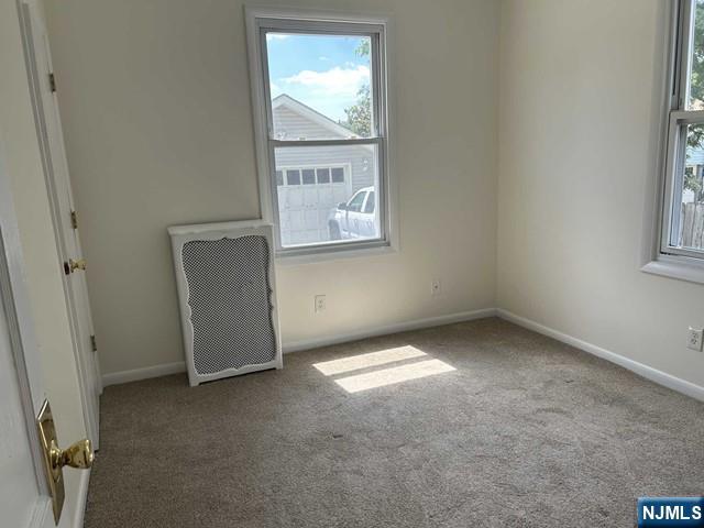 136 Carlton Avenue, Unit 1 East Rutherford, NJ 07073 - Photo 13 of 18 an empty room with windows