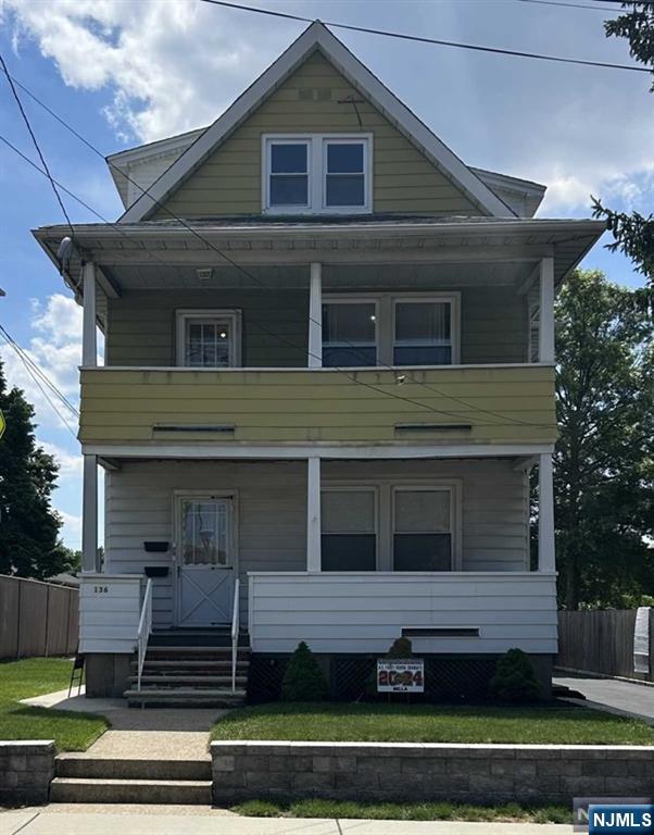 136 Carlton Avenue, Unit 1 East Rutherford, NJ 07073 - Photo 16 of 17 a front view of a house with a yard