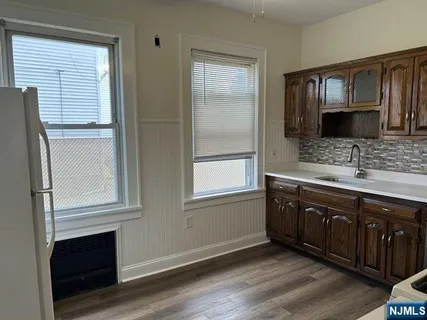 a kitchen with stainless steel appliances granite countertop a stove microwave and sink