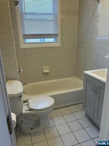 a bathroom with a sink a toilet and bathtub