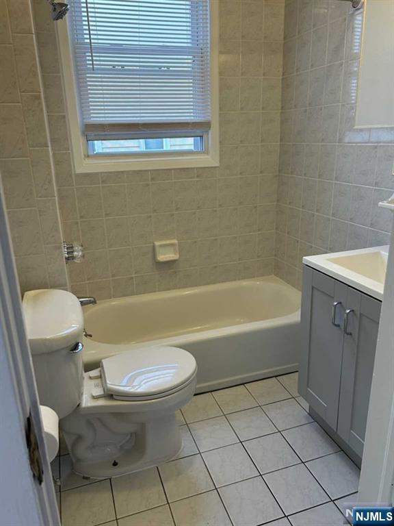 136 Carlton Avenue, Unit 1 East Rutherford, NJ 07073 - Photo 5 of 18 a bathroom with a sink a toilet and bathtub