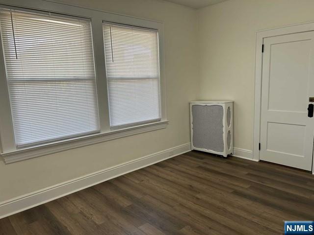 136 Carlton Avenue, Unit 1 East Rutherford, NJ 07073 - Photo 10 of 18 an empty room with wooden floor and windows