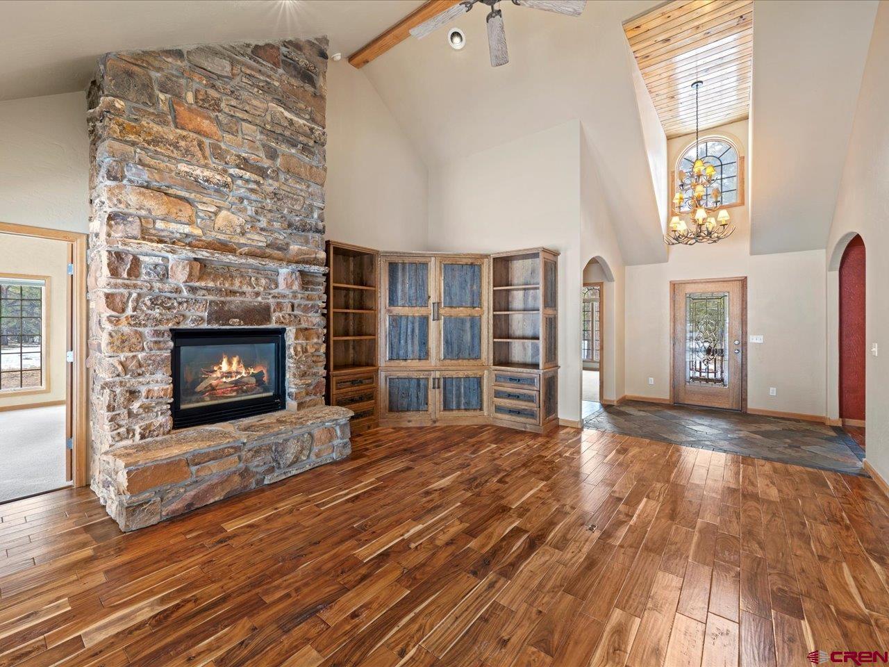203 Puma Lane Ridgway, CO 81432 - Photo 17 of 43 a view of an empty room with wooden floor fireplace and a window