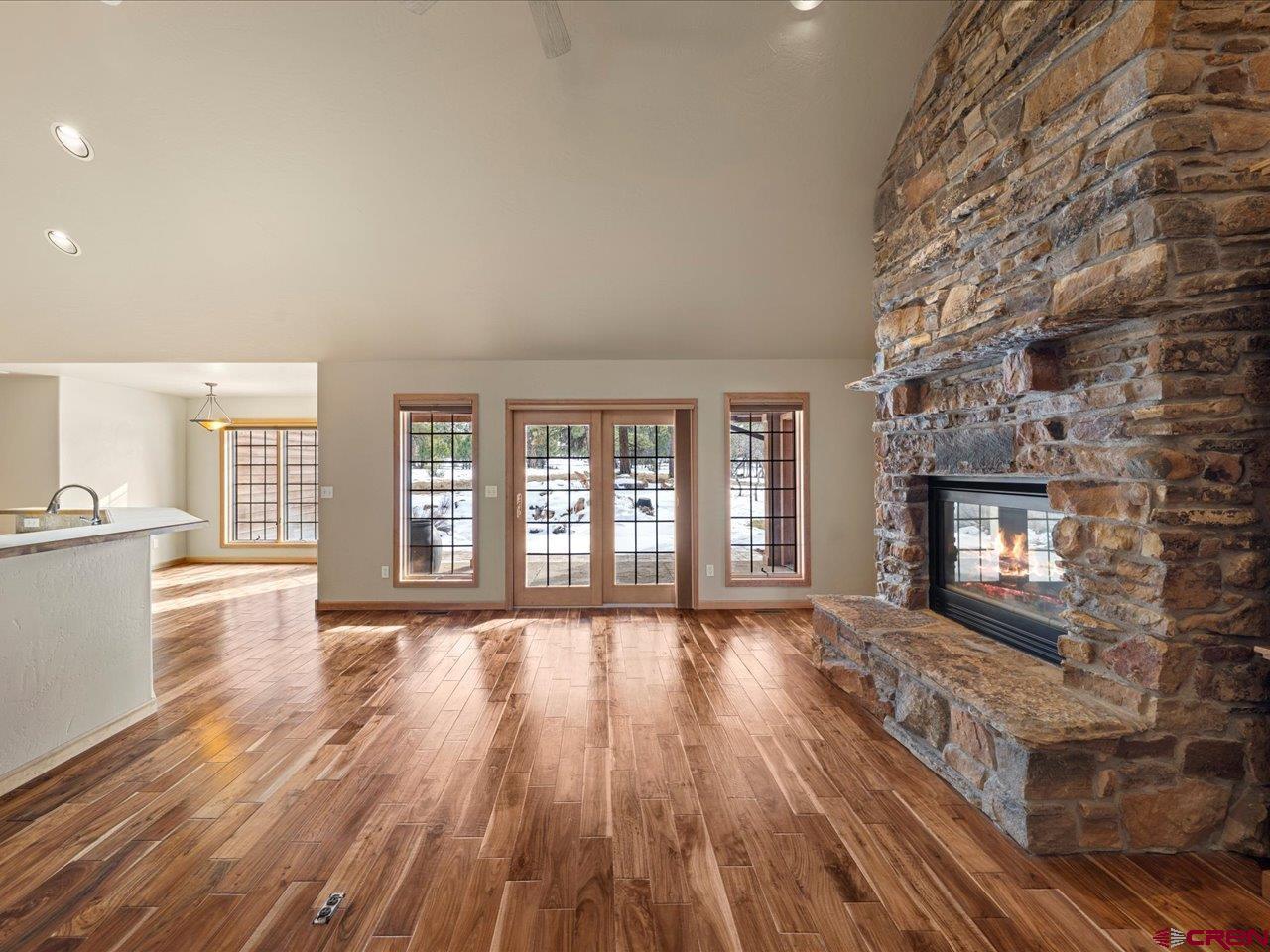 203 Puma Lane Ridgway, CO 81432 - Photo 19 of 43 a view of an empty room with wooden floor and a fireplace