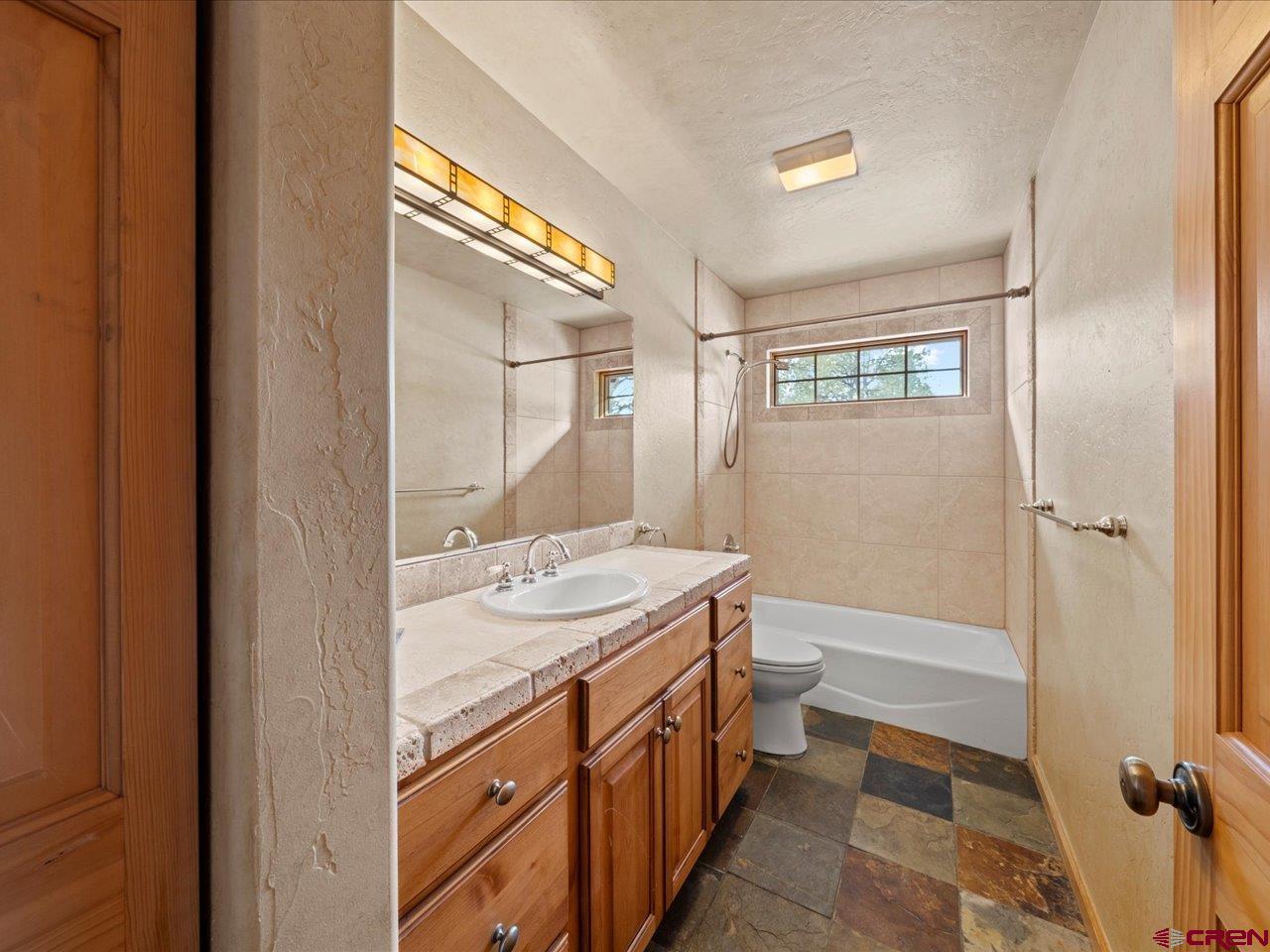 203 Puma Lane Ridgway, CO 81432 - Photo 34 of 43 a bathroom with a granite countertop sink toilet and shower