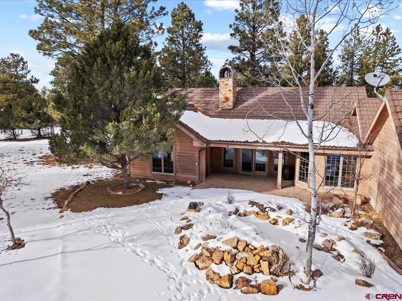 203 Puma Lane Ridgway, CO 81432 - Photo 39 of 43 a front view of a house with a large tree