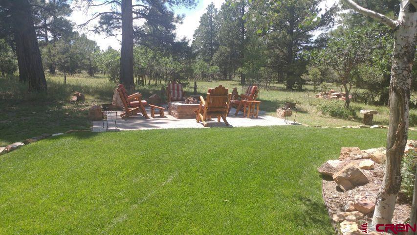 203 Puma Lane Ridgway, CO 81432 - Photo 5 of 43 a view of a lake with lawn chairs and a big yard