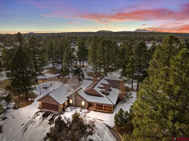 a view of a house with a yard covered in snow