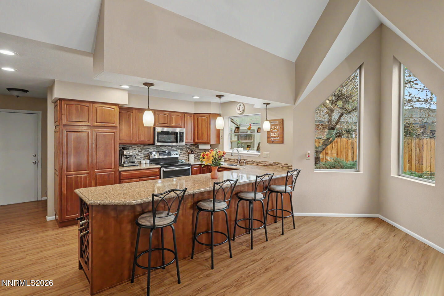 1500 Manchester Circle Fallon, NV 89406 - Photo 8 of 41 a kitchen with stainless steel appliances granite countertop a dining table chairs refrigerator and sink