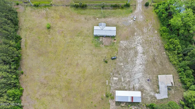 a aerial view of a house with a yard