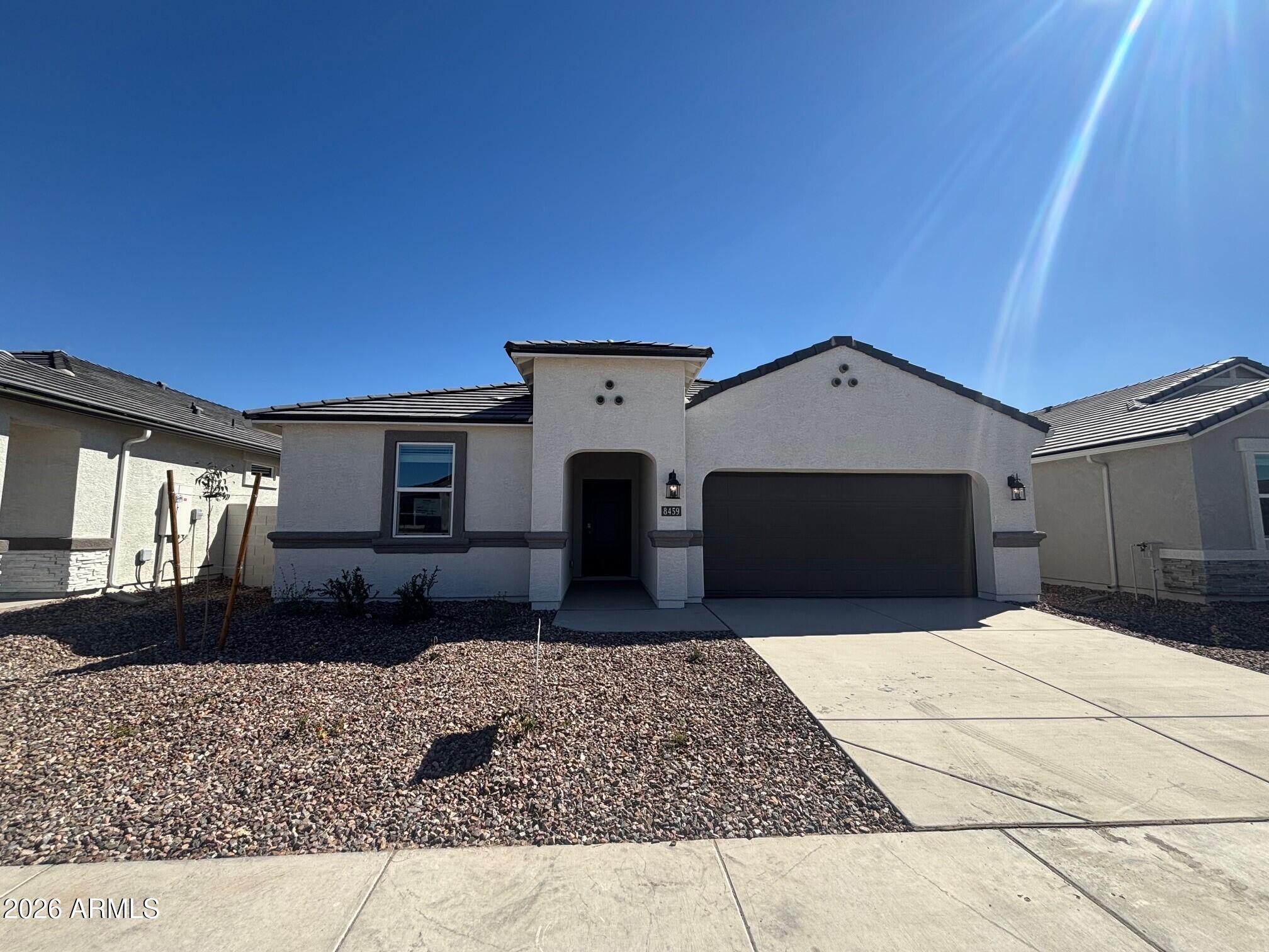 8459 West Gehrig Way Florence, AZ 85132 - Photo 1 of 37 a front view of a house with a yard
