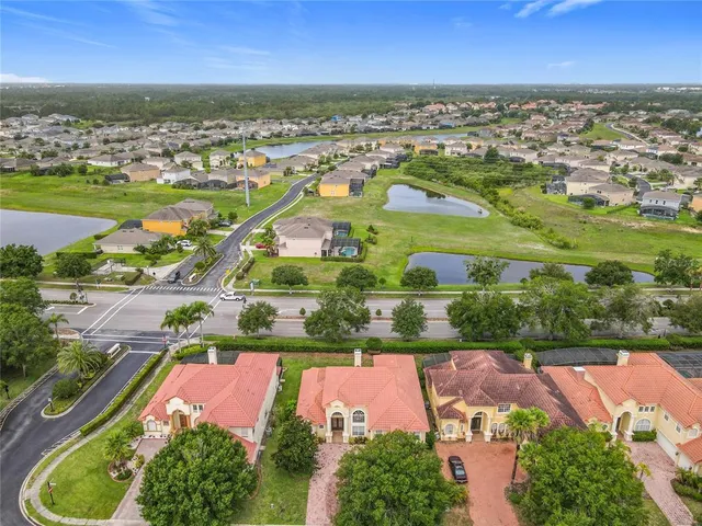 an aerial view of residential houses with outdoor space and river