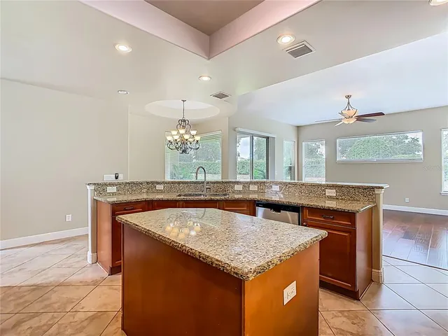 a kitchen with stainless steel appliances granite countertop a stove a refrigerator and a sink