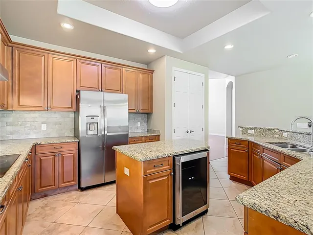 a kitchen with granite countertop cabinets stainless steel appliances and a counter space