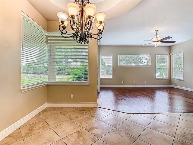 a view of a kitchen with furniture and wooden floor