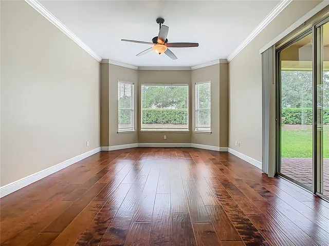 wooden floor in an empty room with a window