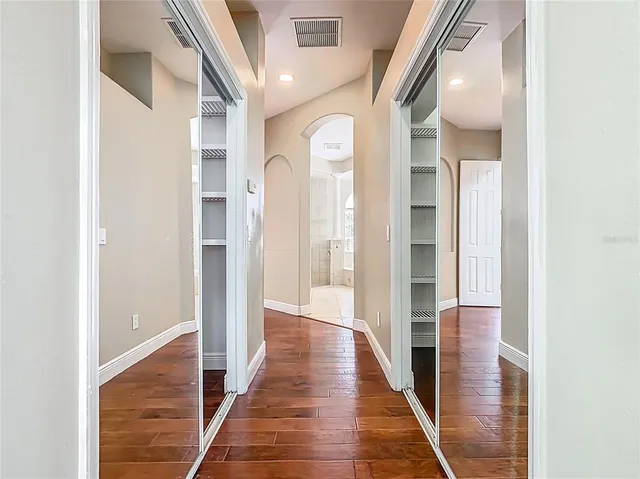 a spacious bathroom with a granite countertop sink a toilet a mirror and shower