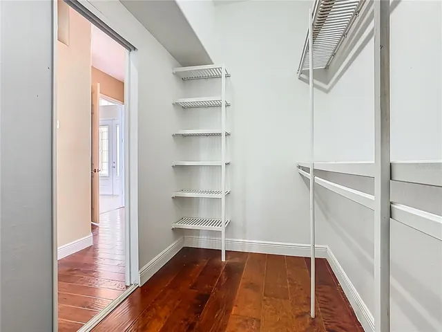 a spacious bathroom with a granite countertop sink and a mirror