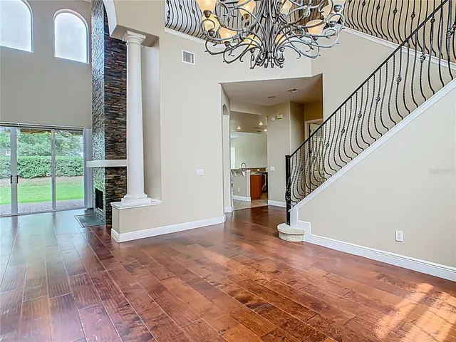 a view of entryway and hall with wooden floor