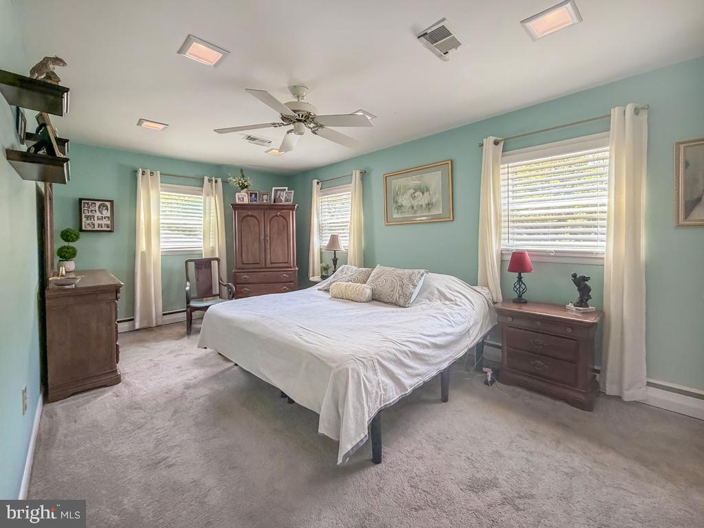 925 Big Oak Road Yardley, PA 19067 - Photo 30 of 51 a spacious bedroom with a bed and a chandelier