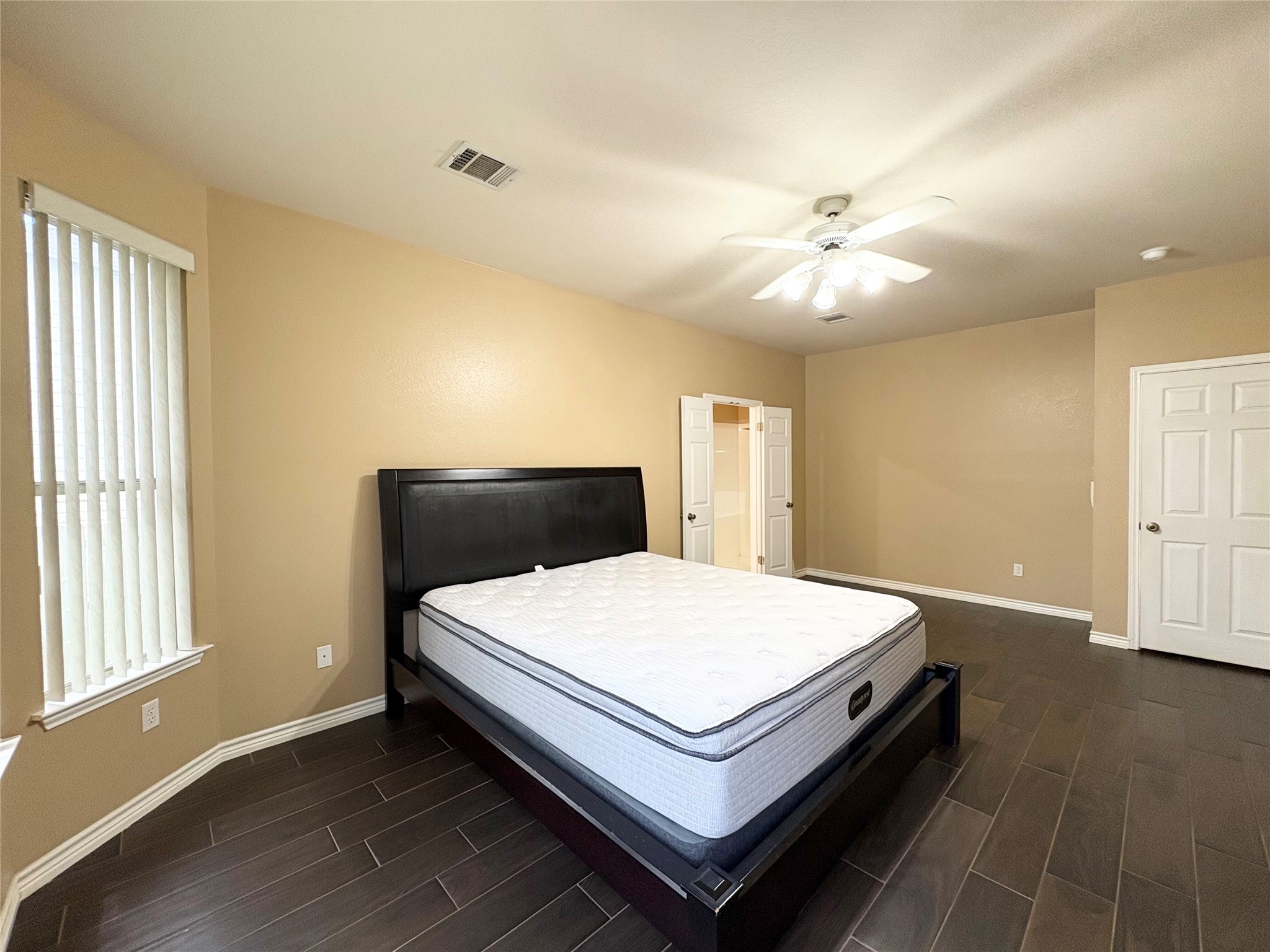 8103 Ephraim Road Austin, TX 78717 - Photo 16 of 35 Rich wood-look flooring anchors this comfortable sleeping sanctuary with ample closet space.