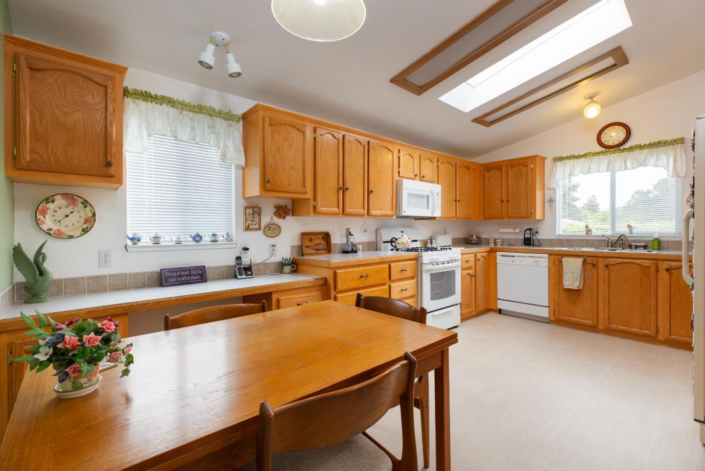 100 North Rodeo Gulch Road, Unit 63 Soquel, CA 95073 - Photo 8 of 21 a kitchen with stainless steel appliances granite countertop a sink counter space and a window