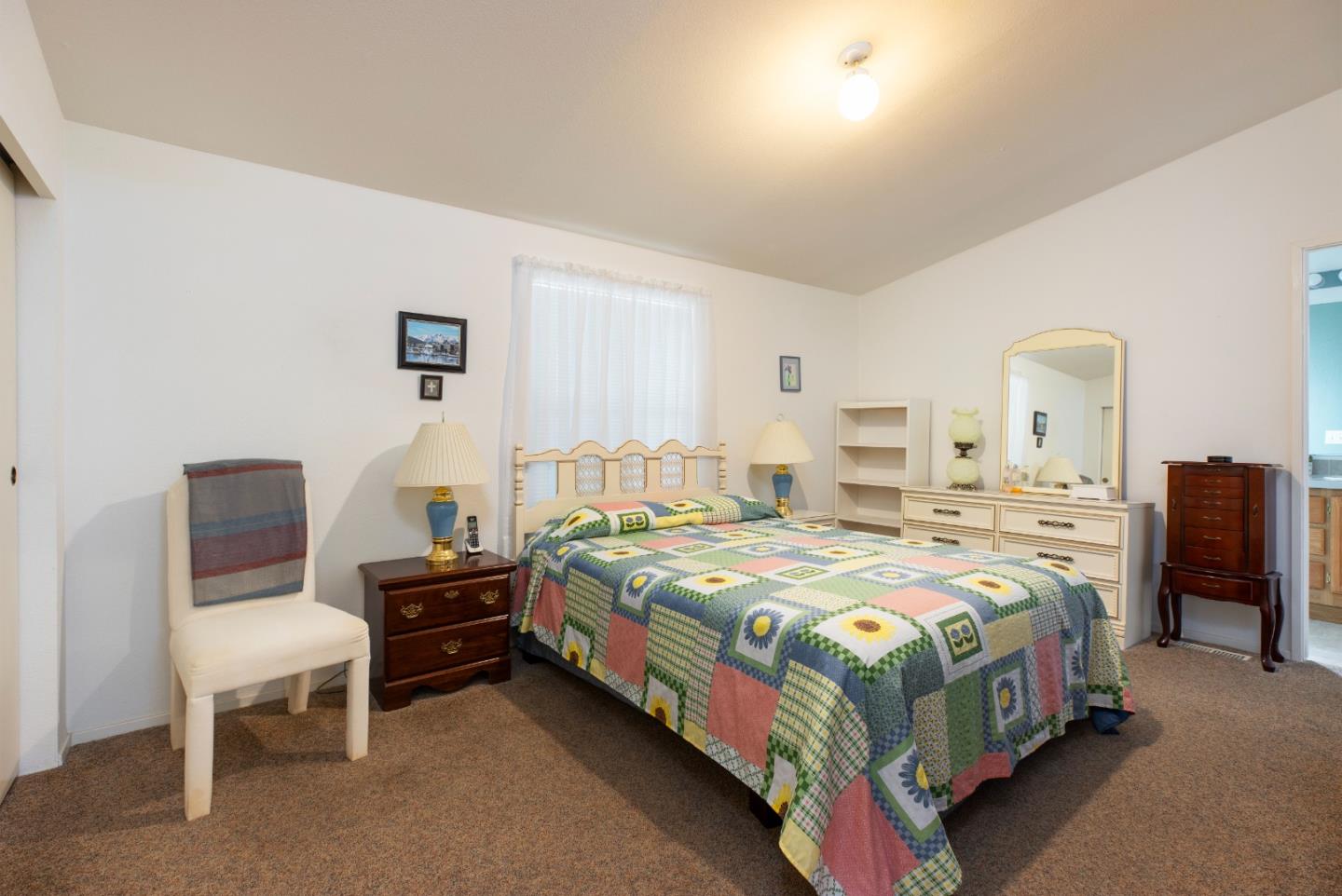 100 North Rodeo Gulch Road, Unit 63 Soquel, CA 95073 - Photo 10 of 21 a bedroom with a bed table chair and a window