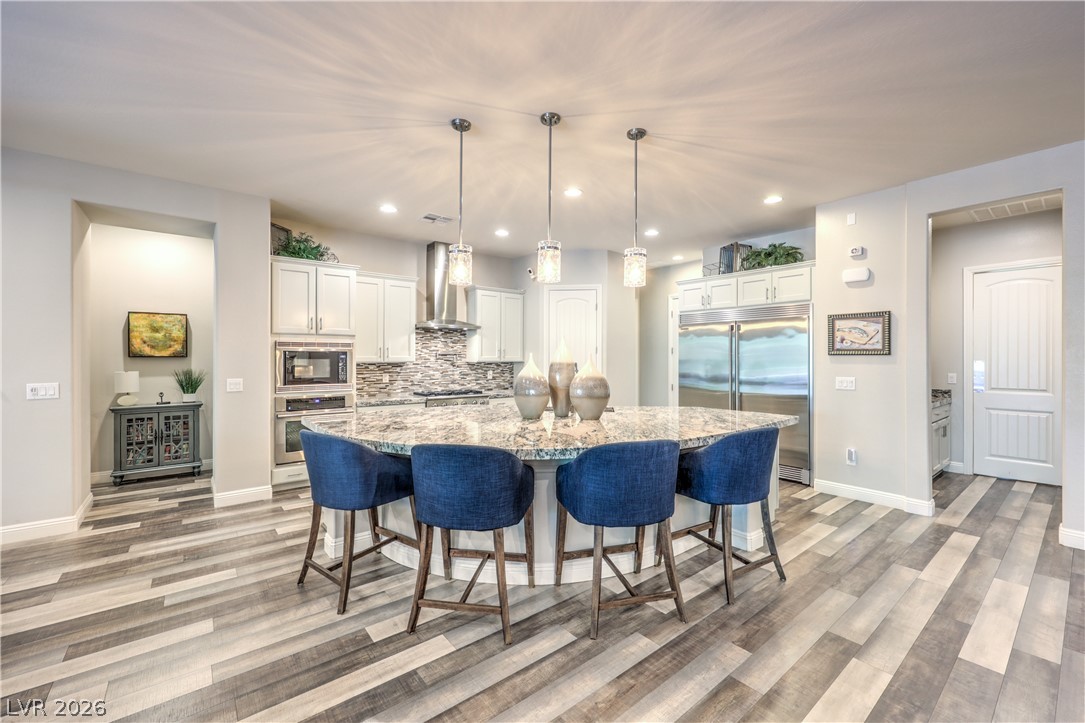 7119 Arabian Ridge Street Las Vegas, NV 89131 - Photo 18 of 73 Granite counters and stainless steel appliances elevate this generously sized kitchen with casual dining island.