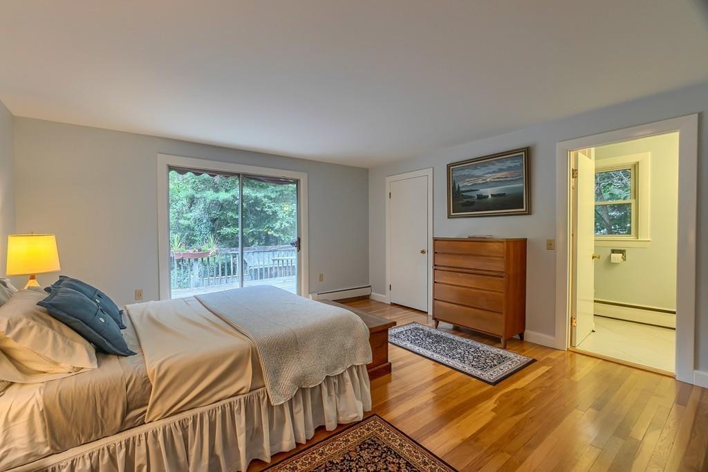 150 Pine Street Manchester, MA 01944 - Photo 17 of 38 a bedroom with a bed and wooden floor