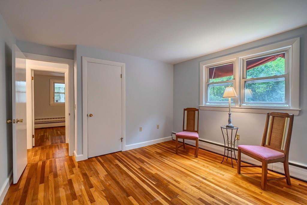 150 Pine Street Manchester, MA 01944 - Photo 20 of 38 a bedroom with a bed and wooden floor
