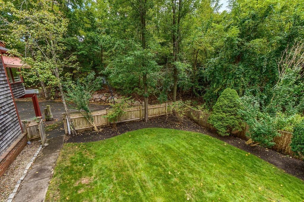 150 Pine Street Manchester, MA 01944 - Photo 35 of 38 a view of a backyard with a bench