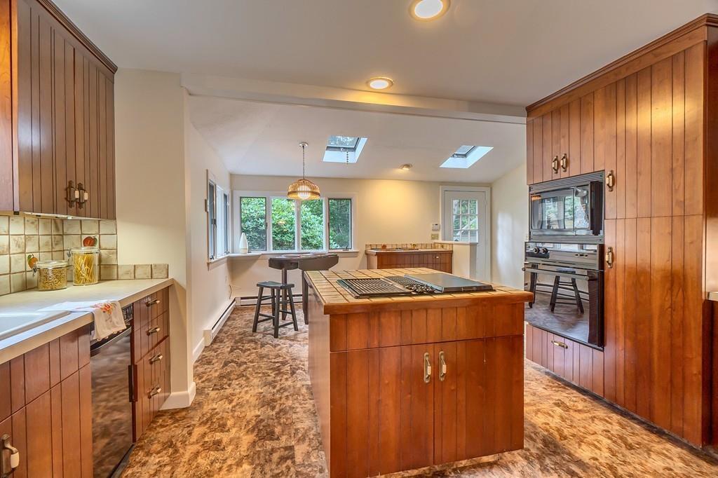 150 Pine Street Manchester, MA 01944 - Photo 9 of 38 a kitchen with a stove a refrigerator a sink dishwasher and wooden cabinets with wooden floor