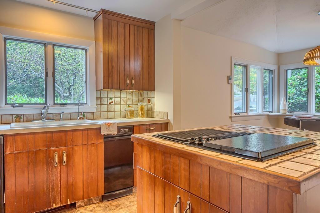 150 Pine Street Manchester, MA 01944 - Photo 10 of 38 a kitchen with stainless steel appliances granite countertop a sink and a stove