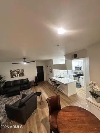a living room with furniture and kitchen view