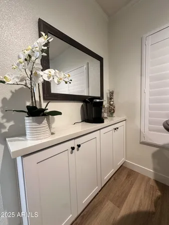 a view of cabinets a sink and dishwasher with wooden floor