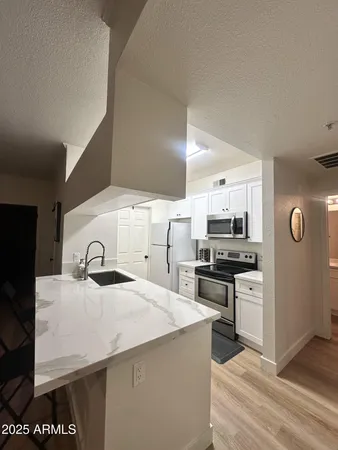 a kitchen with a sink a stove and cabinets