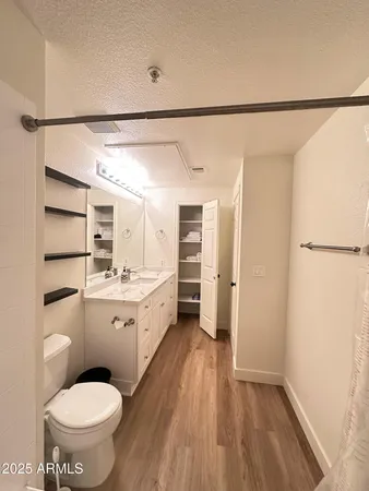 a bathroom with a granite countertop sink toilet and shower