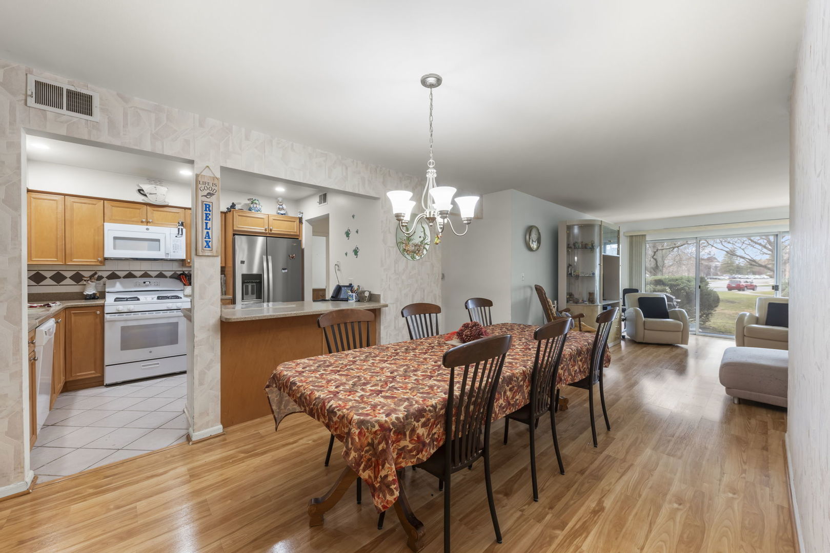 5200 Carriageway Drive, Unit 101 Rolling Meadows, IL 60008 - Photo 6 of 38 a view of a dining room with furniture and wooden floor