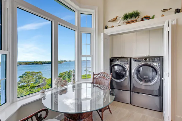 a living room with furniture and a floor to ceiling window