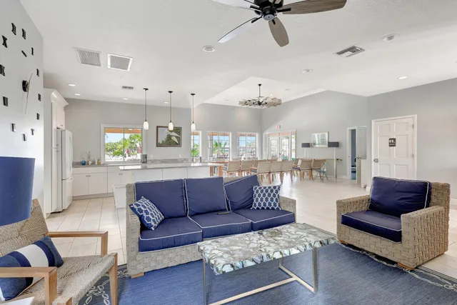 a living room with furniture and kitchen view