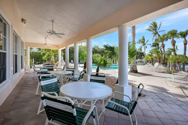 a dining room with furniture and a floor to ceiling window