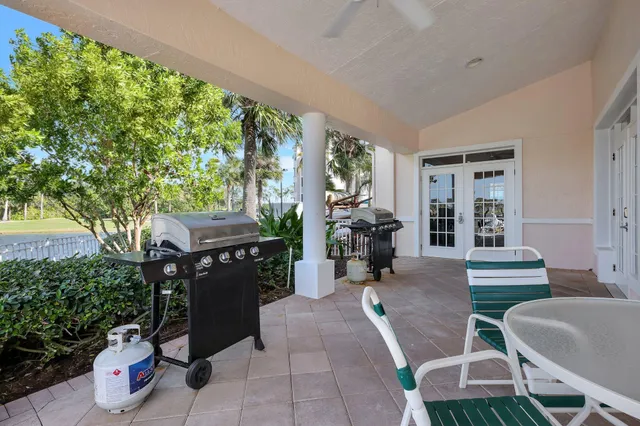 a view of a patio with chairs and potted plants