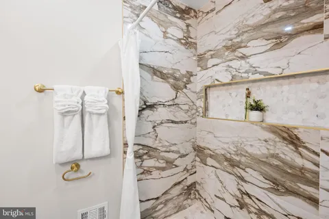 a spacious bathroom with a toilet and a shower