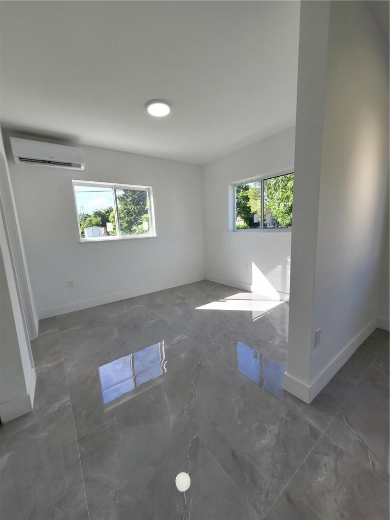 6041 Southwest 17th Street Miami, FL 33155 - Photo 6 of 26 an empty room with windows