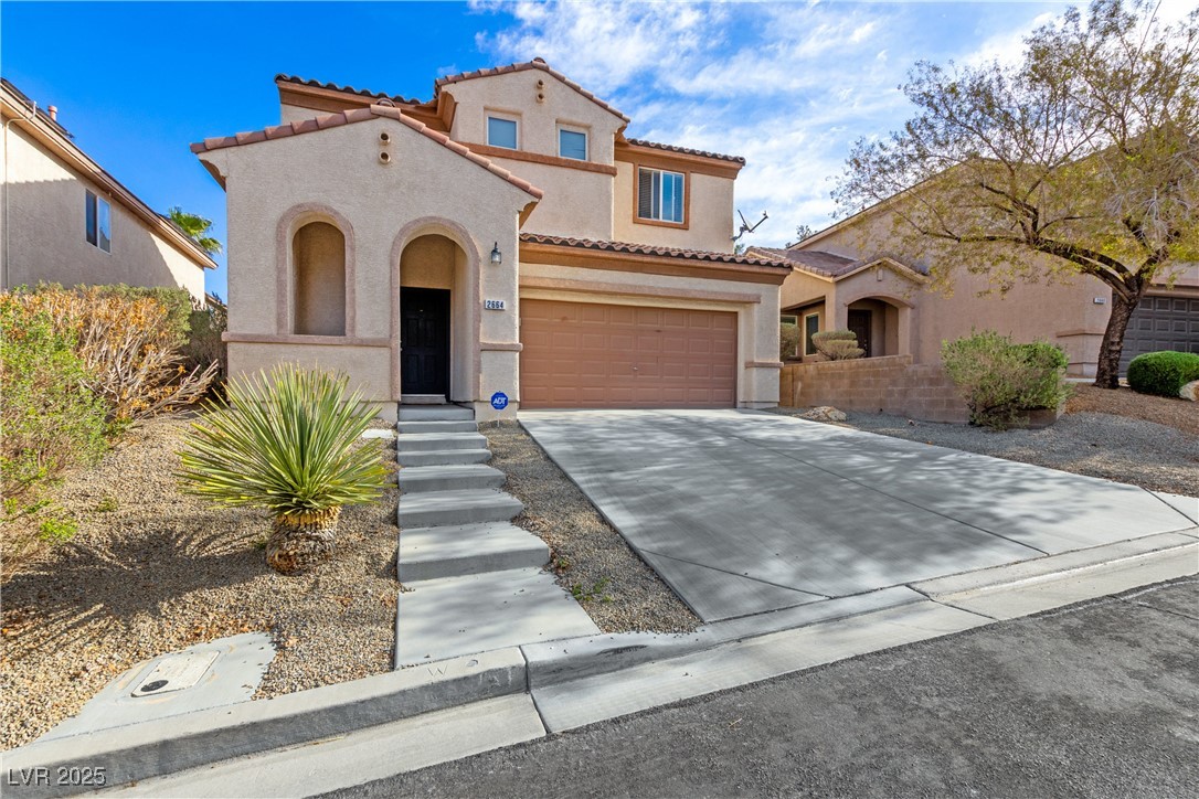 Mediterranean / spanish house featuring a tile roo