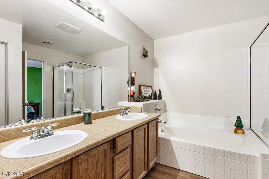 2664 Strichen Avenue Henderson, NV 89044 - Photo 17 of 25 Full bath with a garden tub, visible vents, a sink