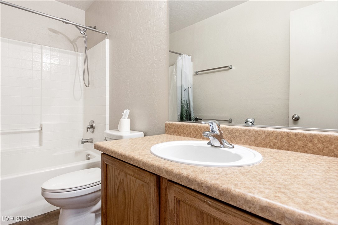 2664 Strichen Avenue Henderson, NV 89044 - Photo 22 of 25 Bathroom featuring a textured wall, toilet, vanity