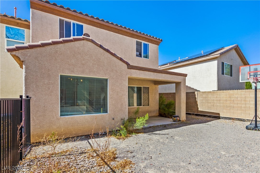 2664 Strichen Avenue Henderson, NV 89044 - Photo 25 of 25 Back of property with stucco siding, fence, and a